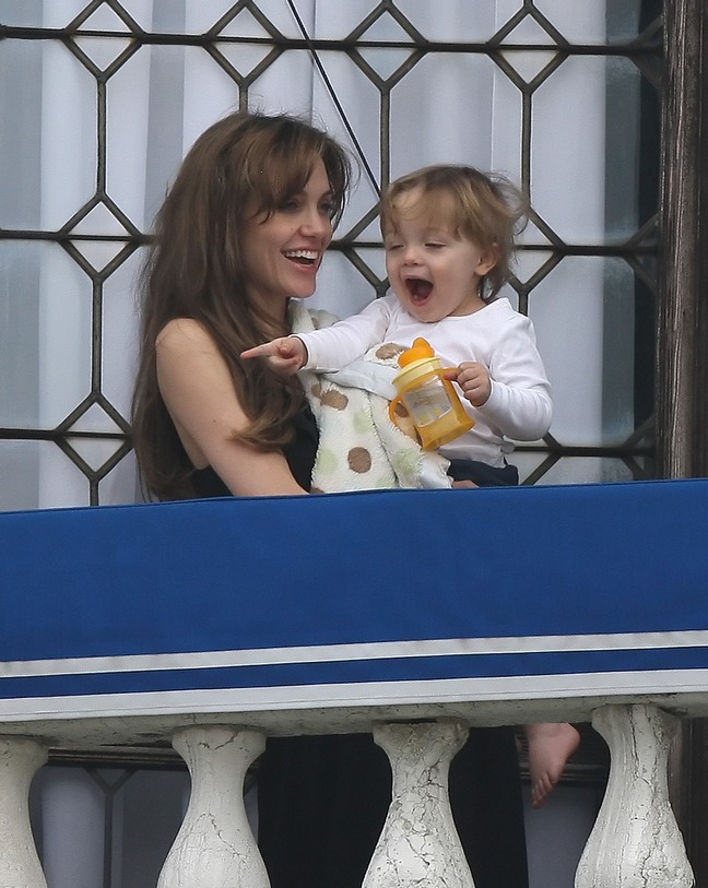 Angelina Jolie black sleeveless shirt on balcony